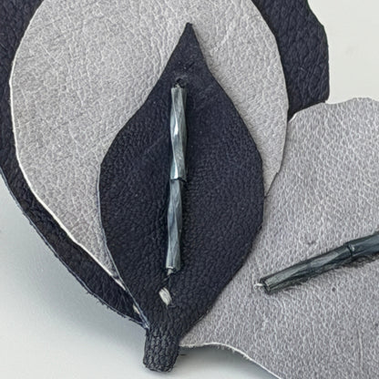  close-up of a handmade leaf-shaped leather accessory