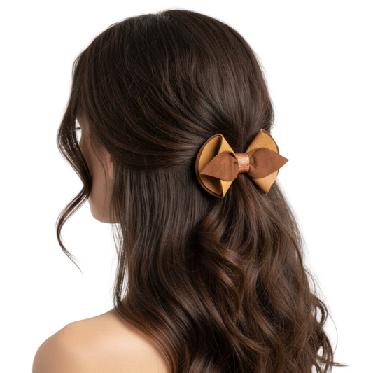 Model wearing multi-toned leather bow hair clip