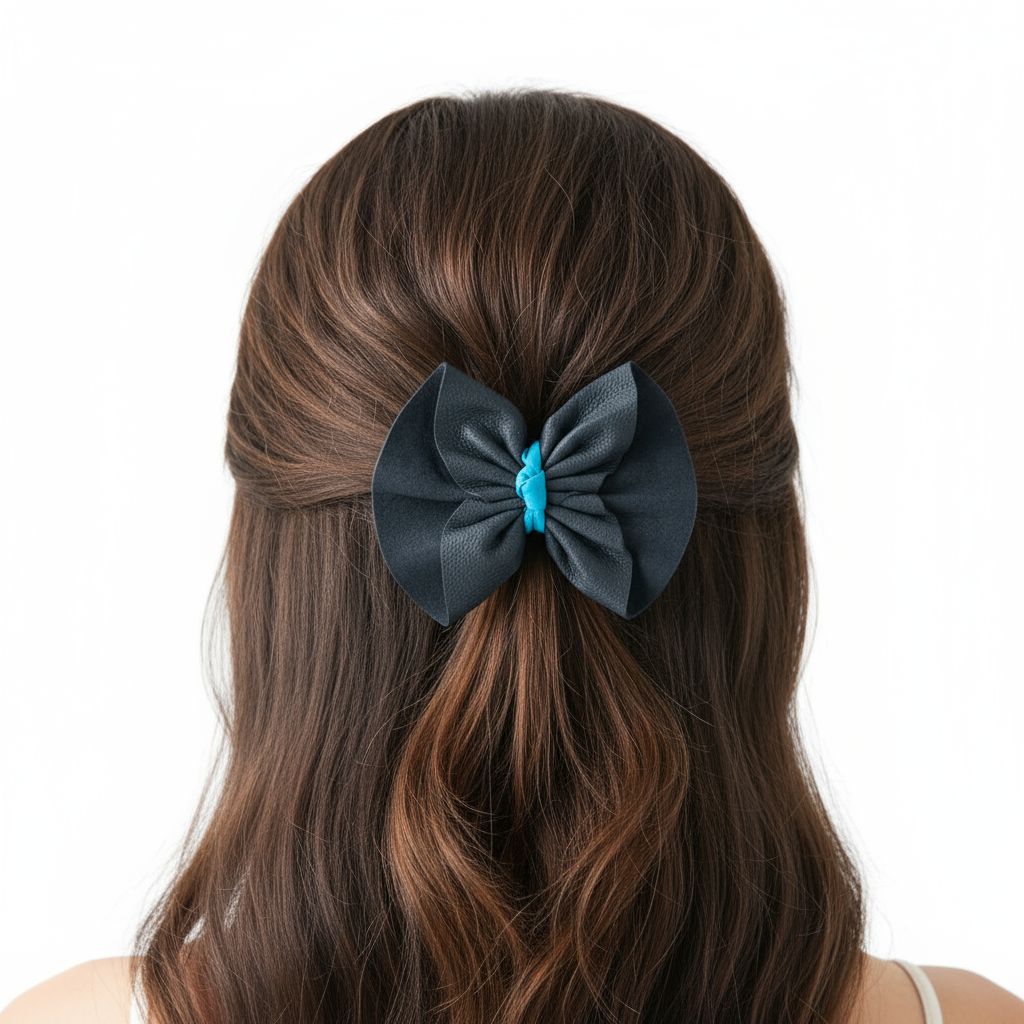 Model wearing navy and turquoise leather bow hair clip with white background