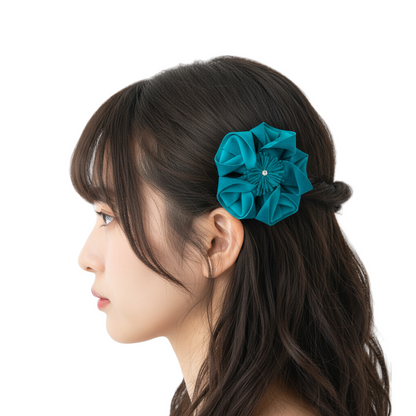 Teal flower worn as decorative hair clip