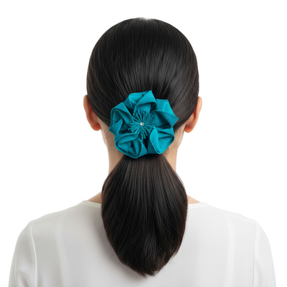 Teal flower worn as hair tie in ponytail